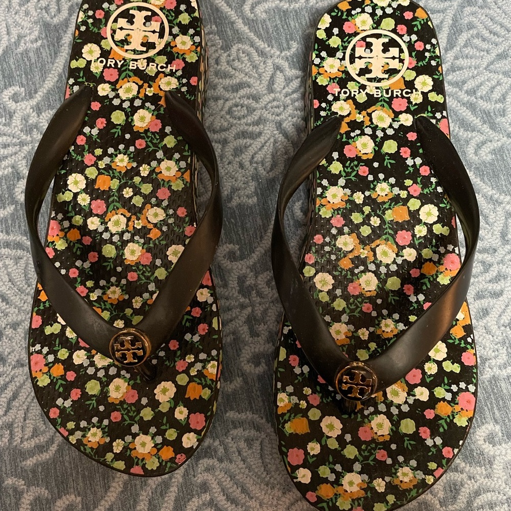 Tory Burch Black Floral Logo Flip Flop Sandals with Bronze Medallion